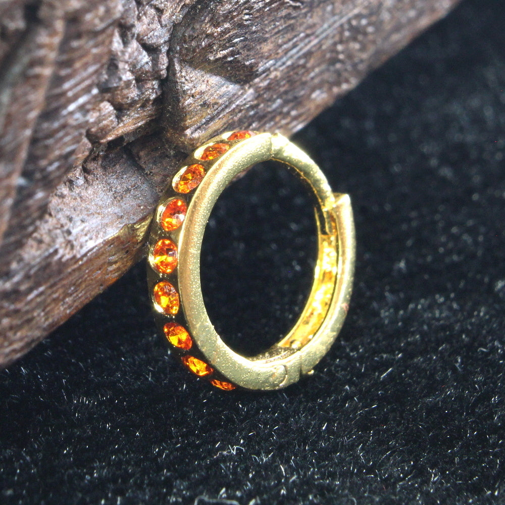 Gold plated clicker nose ring with orange stones.
