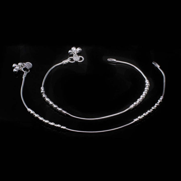 Light weight silver anklet for women with bells.