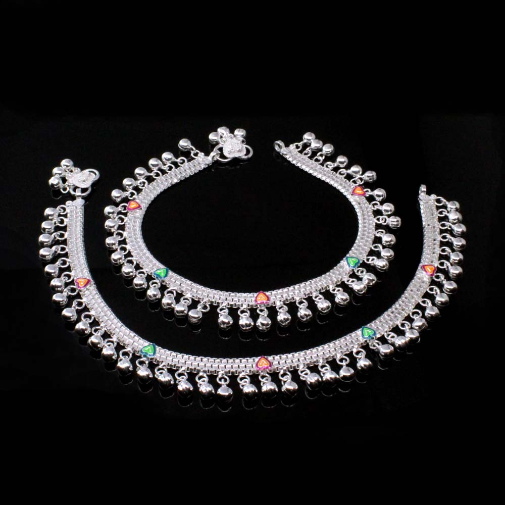 Heavy weight silver anklet with dangling bells on a black background.