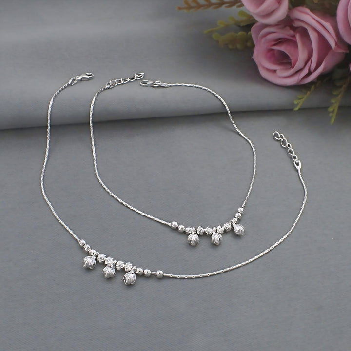 Beautiful pair of silver anklets with delicate floral-inspired charms, elegantly designed to add grace and feminine charm to every step.