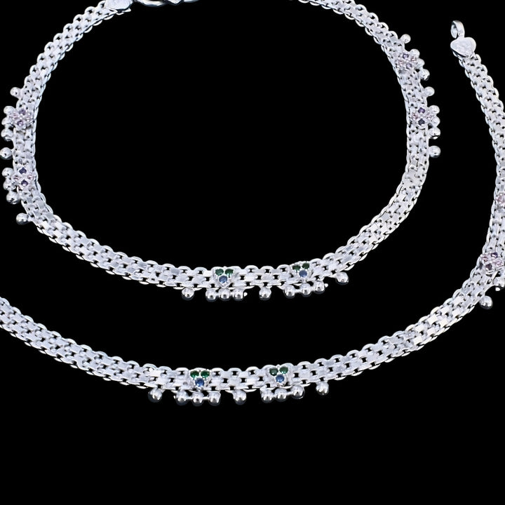 This image shows a pair of traditional Indian silver anklets, also known as anklet, displayed against a solid black background.