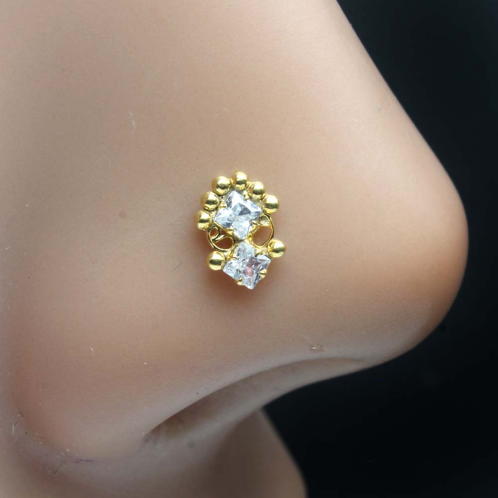 Gold plated nose ring stud on nose. 